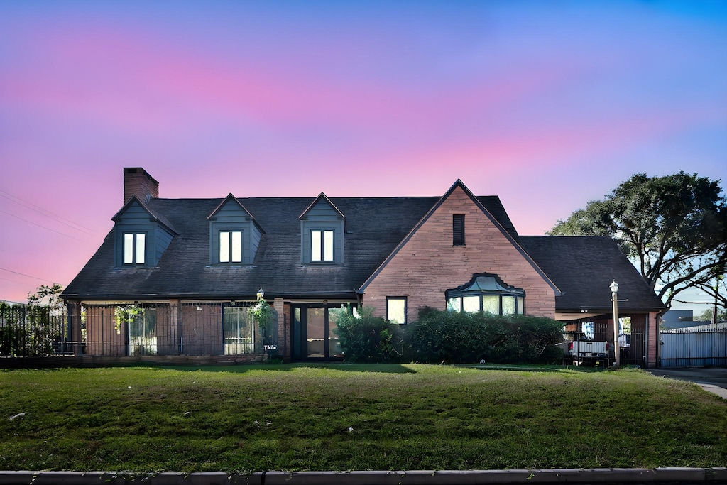7846 Santa Elena St, Houston, TX 77061 - view of front facade with a front yard, a chimney, and brick siding