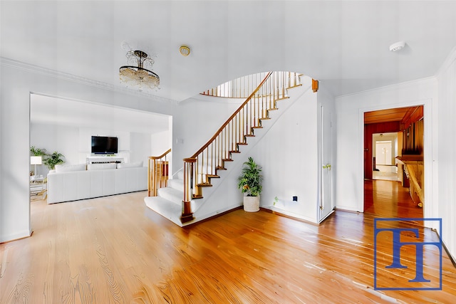 interior space with hardwood / wood-style flooring and crown molding