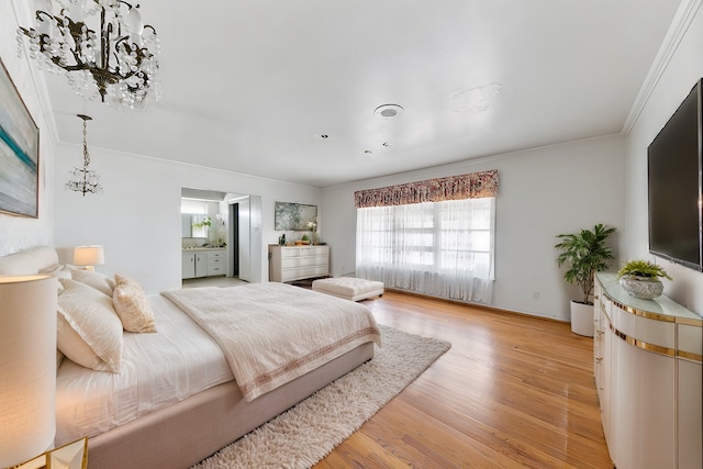 bedroom featuring connected bathroom, light hardwood / wood-style floors, and ornamental molding