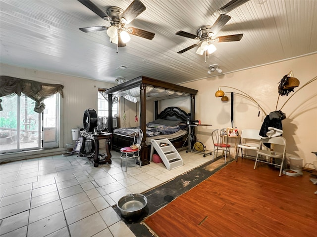 bedroom with ceiling fan and light tile patterned flooring