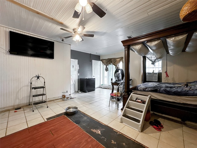 tiled bedroom featuring ceiling fan