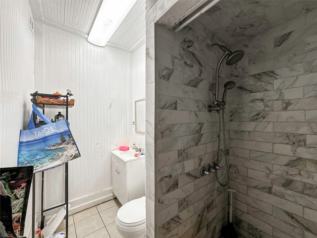 bathroom featuring tile patterned floors, toilet, sink, and tiled shower