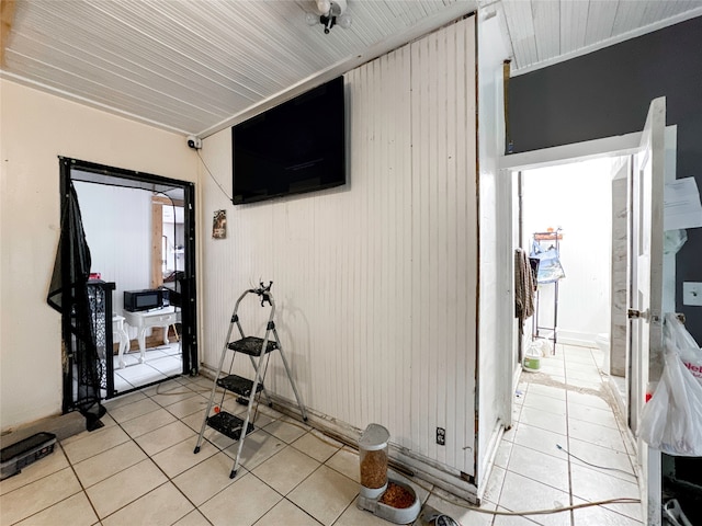 workout room featuring light tile patterned floors