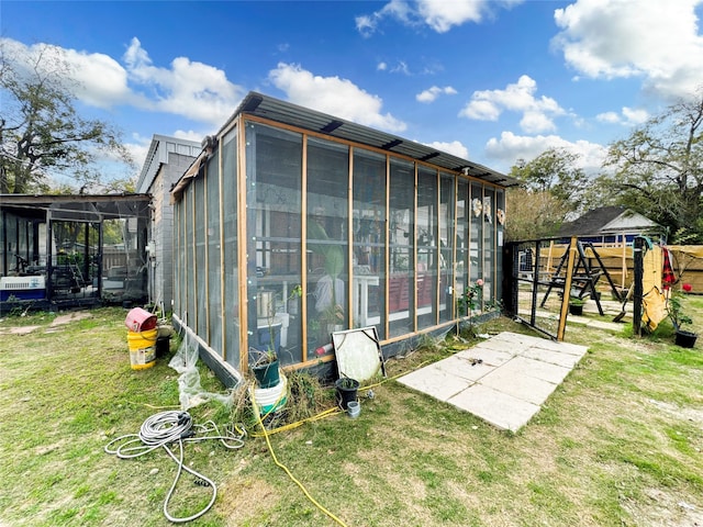 view of outdoor structure featuring a playground and a yard