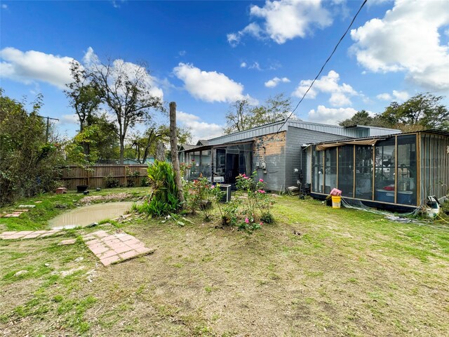 view of yard featuring a sunroom