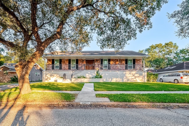 ranch-style home with a front yard and a porch