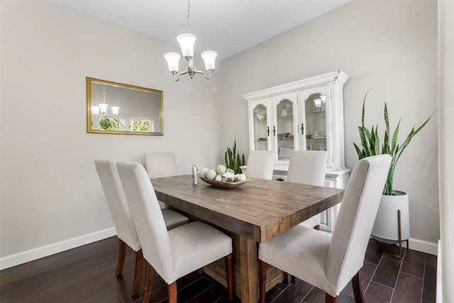 dining space featuring dark hardwood / wood-style flooring and a chandelier