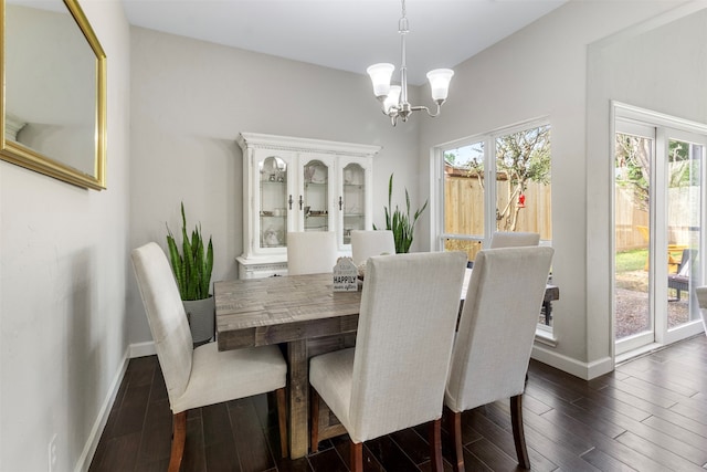 dining room featuring dark hardwood / wood-style floors and an inviting chandelier