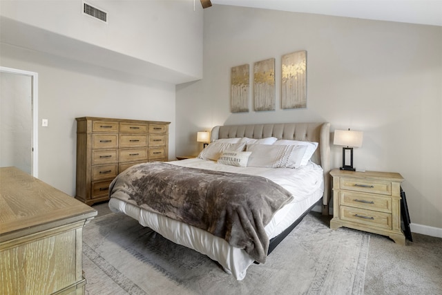 carpeted bedroom featuring ceiling fan and high vaulted ceiling