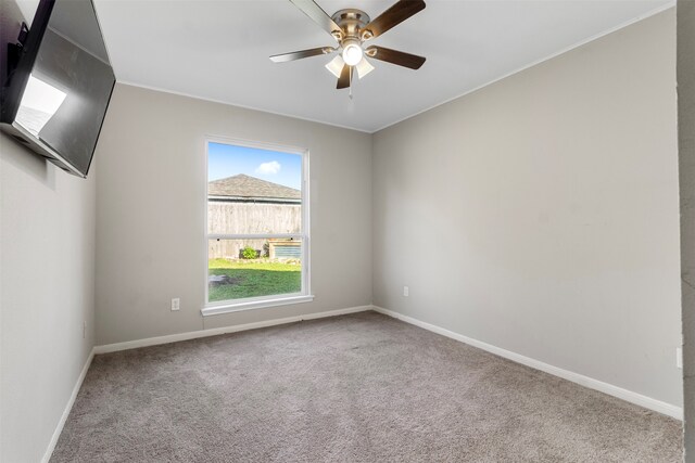 spare room featuring carpet flooring and ceiling fan