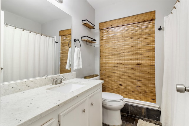 bathroom with tile patterned floors, vanity, and toilet