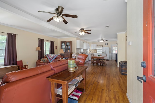 living room featuring wood-type flooring and ceiling fan