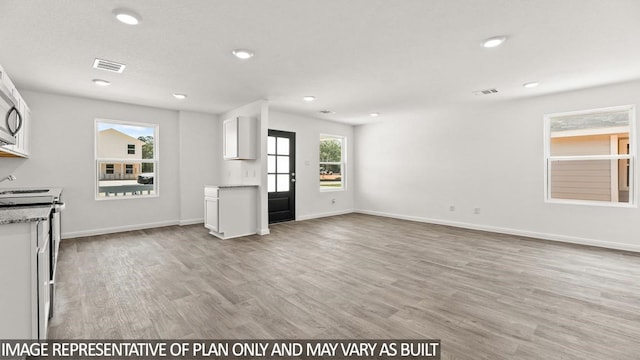 unfurnished living room with light hardwood / wood-style flooring