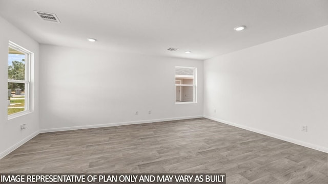 unfurnished room with light wood-type flooring