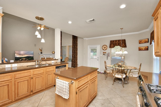 kitchen with appliances with stainless steel finishes, ornamental molding, sink, light tile patterned floors, and a center island