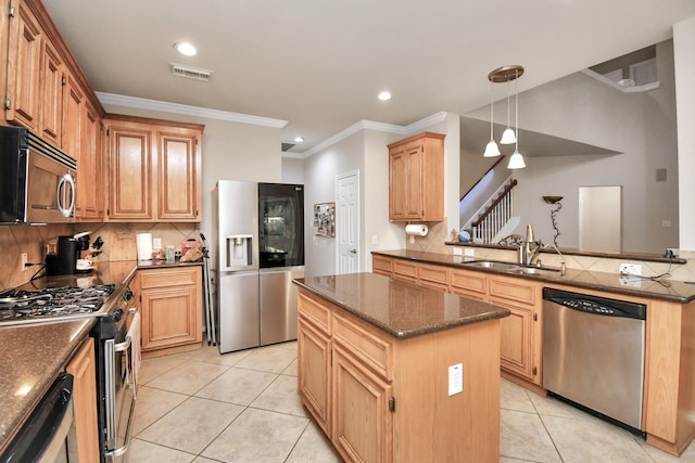 kitchen with sink, a center island, backsplash, crown molding, and appliances with stainless steel finishes