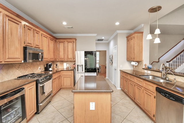 kitchen with sink, decorative light fixtures, a kitchen island, stainless steel appliances, and beverage cooler