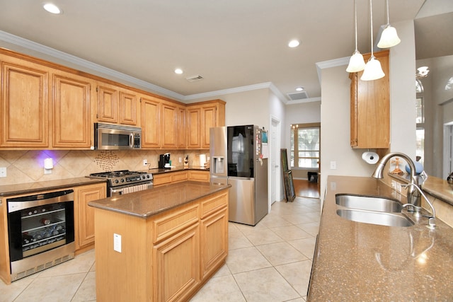 kitchen featuring sink, a center island, beverage cooler, dark stone counters, and appliances with stainless steel finishes