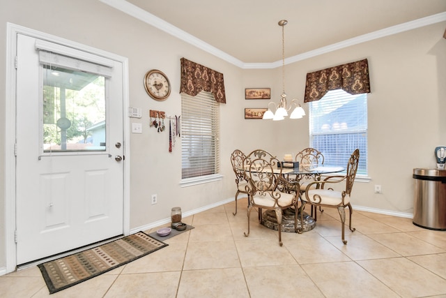 dining room featuring light tile patterned floors, a wealth of natural light, ornamental molding, and a notable chandelier