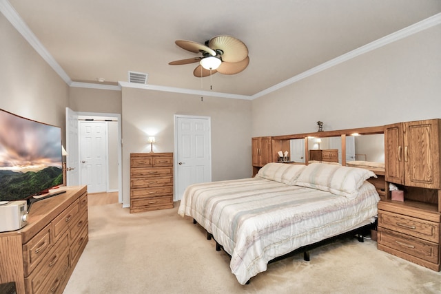 bedroom with ceiling fan, light colored carpet, and crown molding