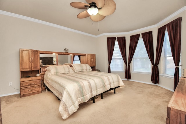 carpeted bedroom featuring ceiling fan and crown molding