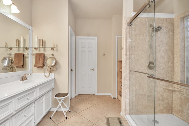 bathroom featuring tile patterned flooring, vanity, and a shower with shower door