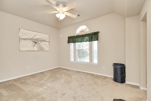 carpeted spare room featuring ceiling fan