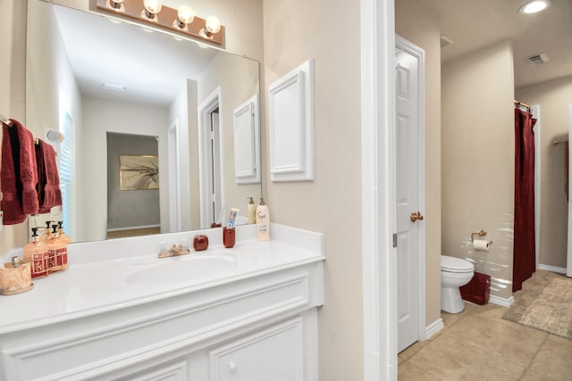 bathroom featuring tile patterned flooring, vanity, and toilet