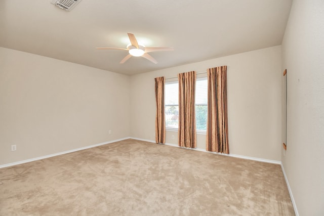 carpeted spare room featuring ceiling fan