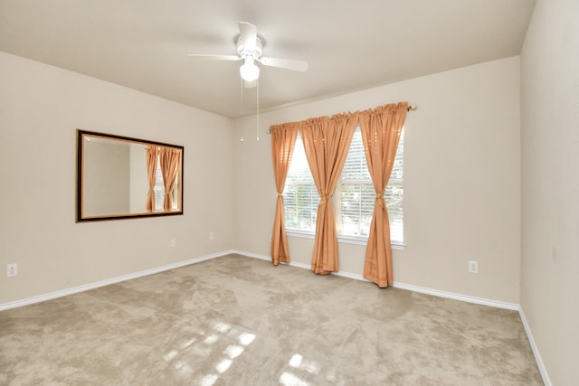 carpeted spare room with ceiling fan