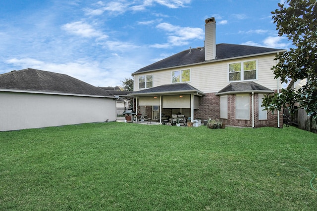 back of property featuring a yard and a patio