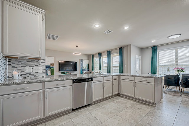 kitchen featuring dishwasher, decorative backsplash, kitchen peninsula, and plenty of natural light