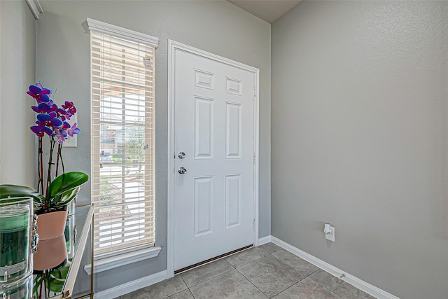 doorway to outside featuring light tile patterned flooring