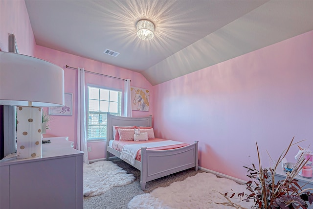 bedroom featuring light carpet and vaulted ceiling