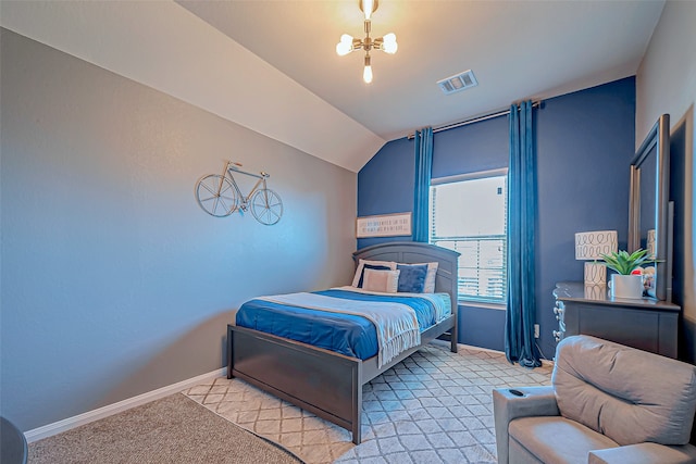 carpeted bedroom with a notable chandelier and lofted ceiling