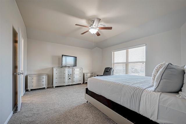 carpeted bedroom with vaulted ceiling and ceiling fan