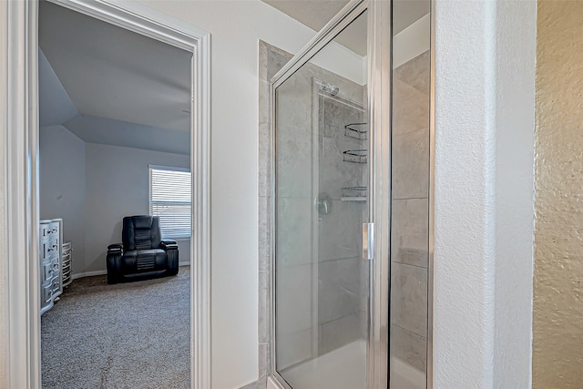 bathroom featuring a shower with shower door and vaulted ceiling