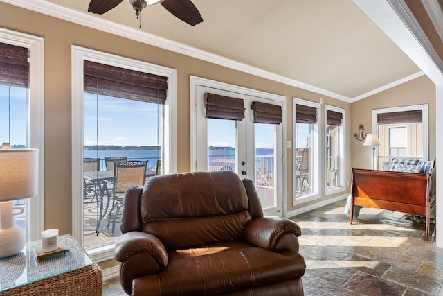 sunroom / solarium featuring a water view, a healthy amount of sunlight, and lofted ceiling