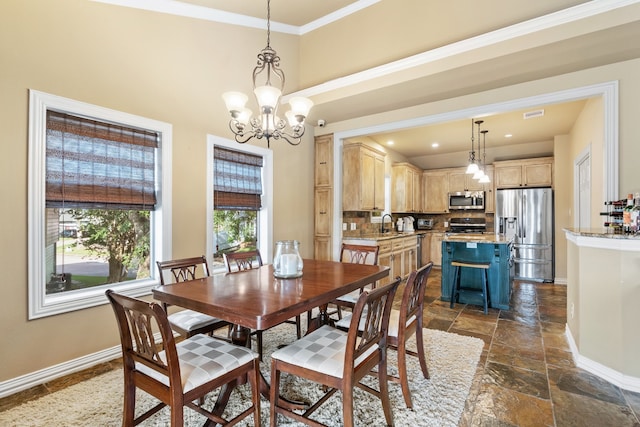 dining room with crown molding, sink, and an inviting chandelier