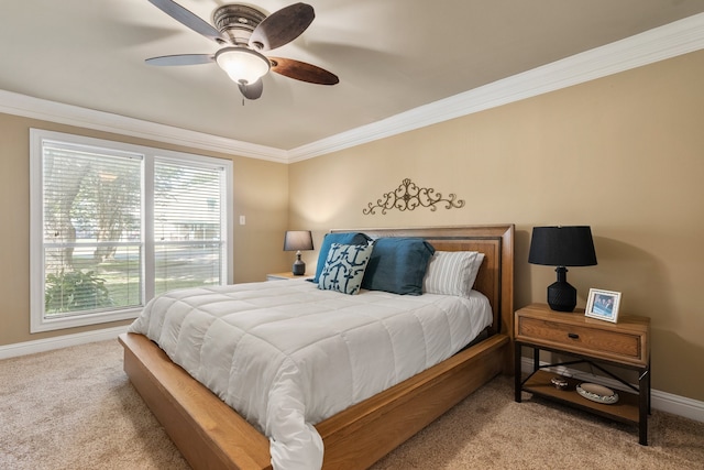 carpeted bedroom featuring ceiling fan and crown molding