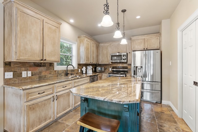 kitchen with sink, a center island, a breakfast bar area, light brown cabinetry, and appliances with stainless steel finishes