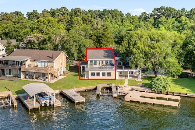 exterior space with a yard, a balcony, and a deck with water view