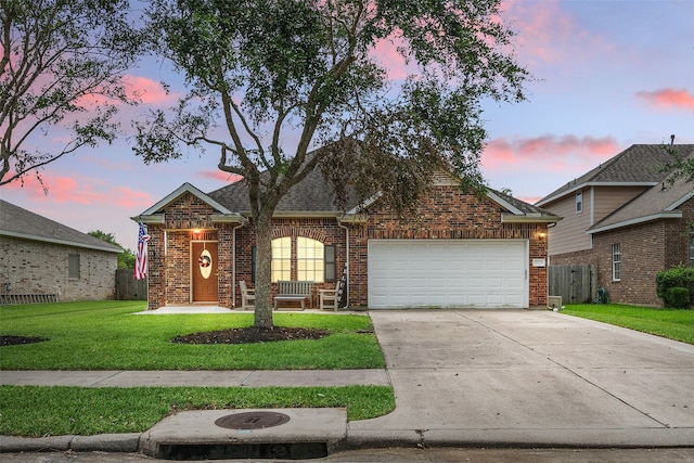 view of front facade with a lawn and a garage