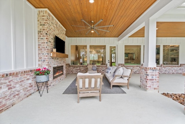 view of patio / terrace featuring an outdoor living space with a fireplace and ceiling fan