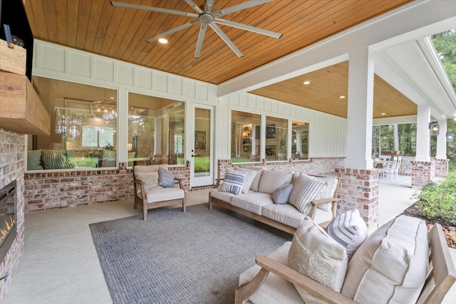 sunroom featuring a wealth of natural light, wooden ceiling, and ceiling fan