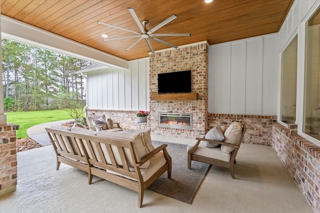 view of patio / terrace featuring an outdoor living space with a fireplace and ceiling fan