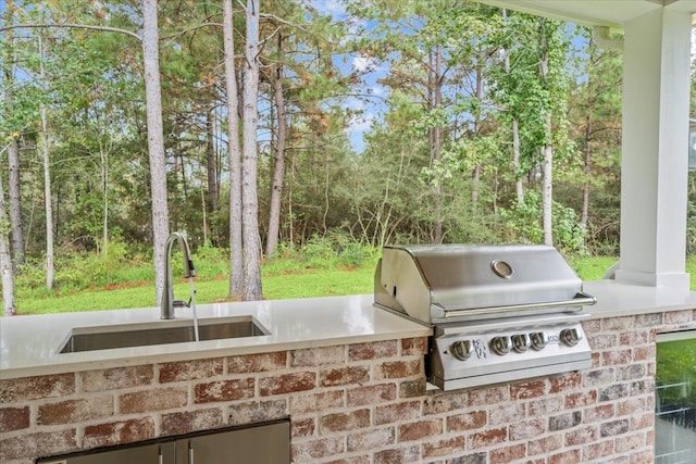 view of patio / terrace with an outdoor kitchen, area for grilling, and sink