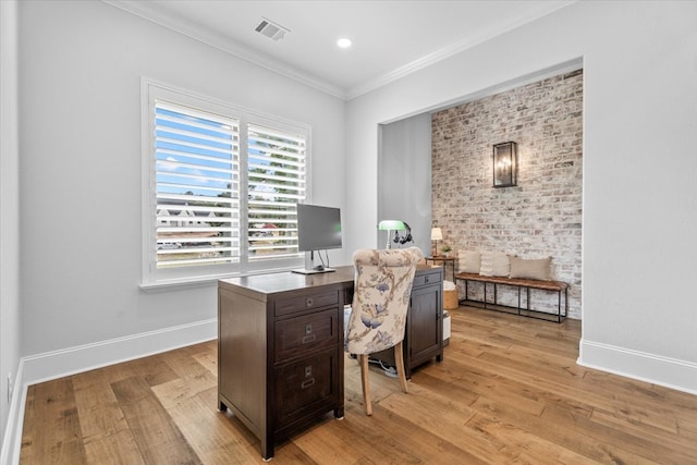 office with crown molding and light hardwood / wood-style floors