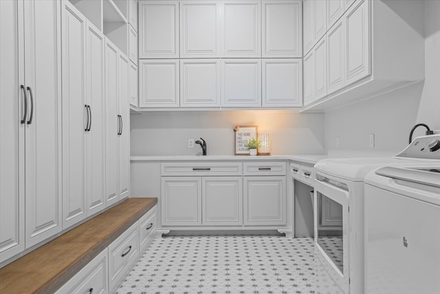 laundry room with sink, cabinets, and independent washer and dryer