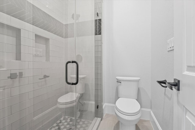 bathroom featuring tile patterned floors, a shower with shower door, and toilet